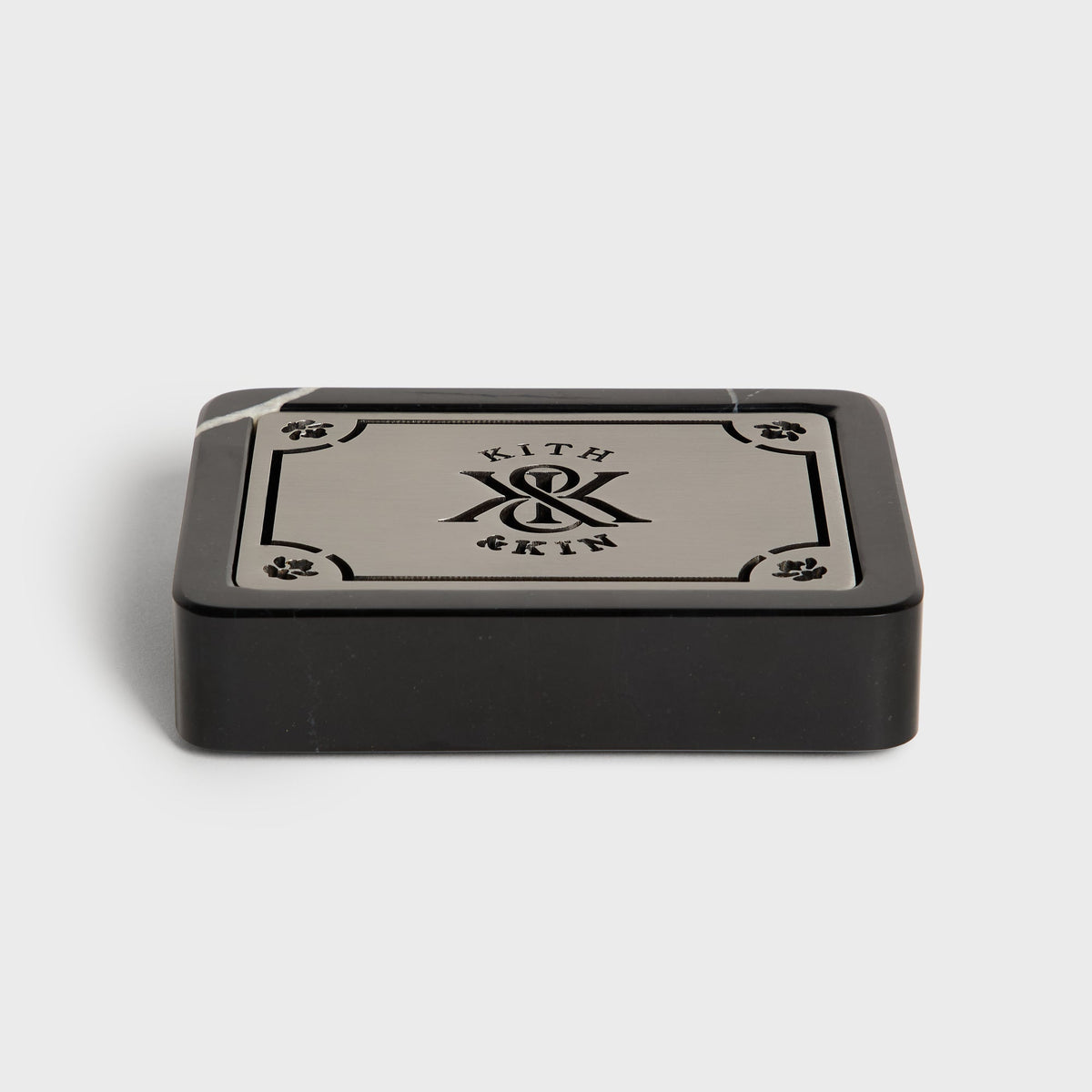 Black marble Kith soap dish, angled view, with metal lid