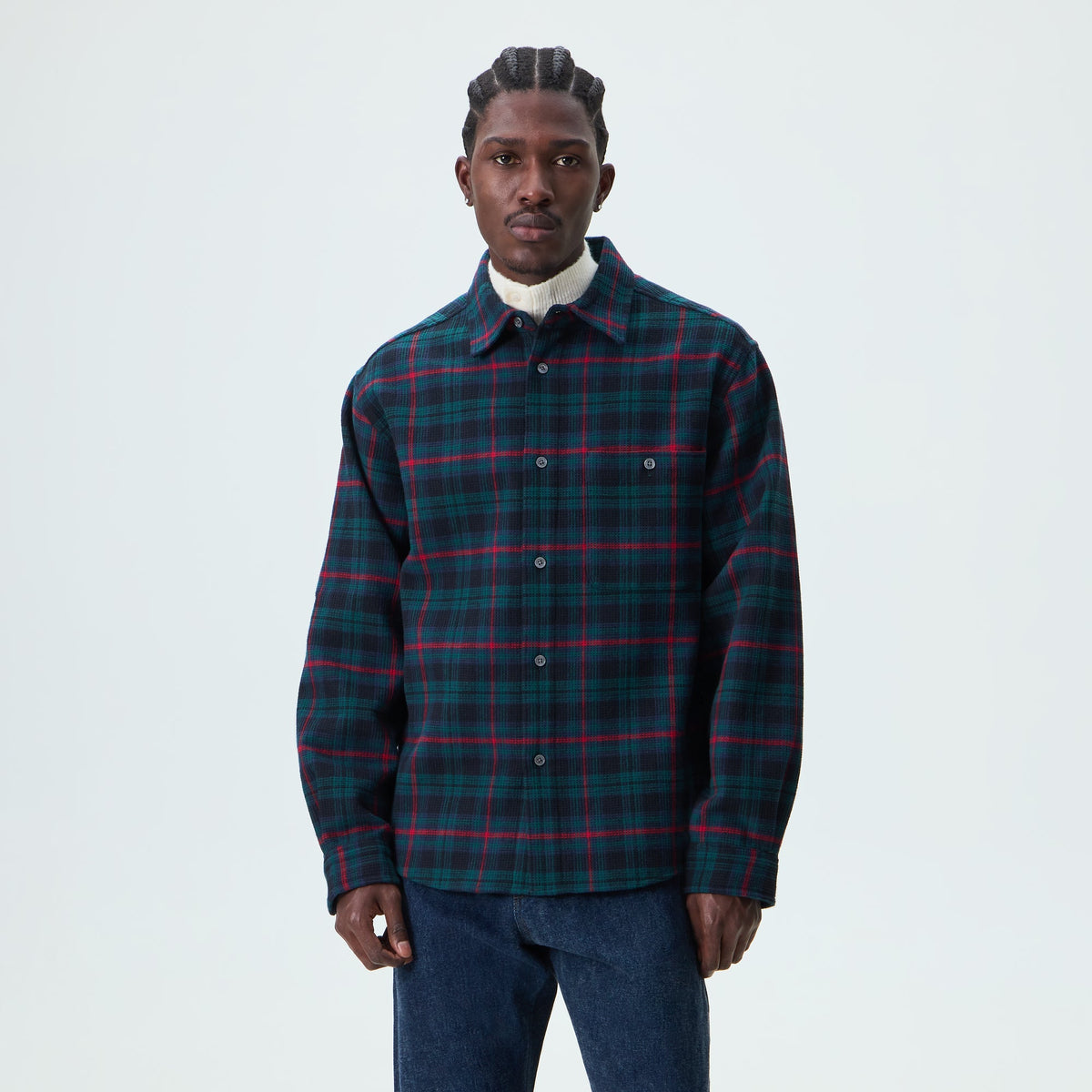 Man wearing the navy and green plaid Kith Waffle Plaid Tomas buttondown shirt, front view