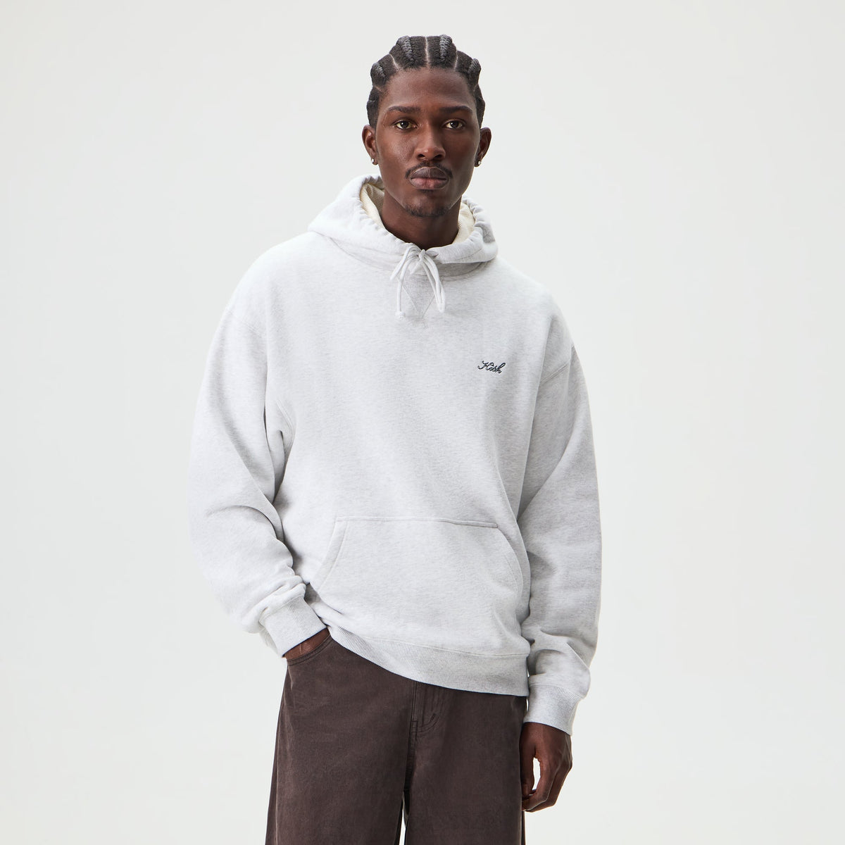 Man wearing light heather grey Kith Thermal Lined Fleece Williams II hoodie, front view