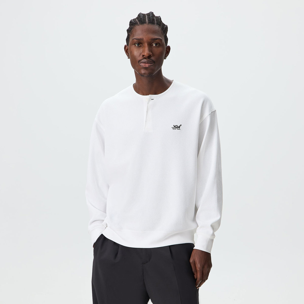 Man wearing white Kith Micro Waffle long-sleeve Colby henley, front view