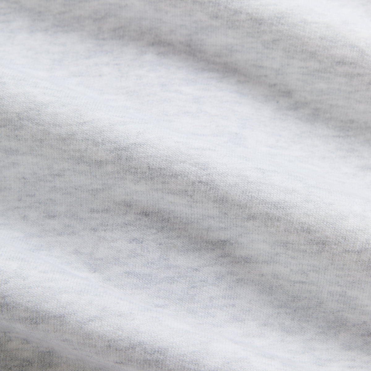 Close-up of light heather grey fleece fabric of the Kith Braxton full-zip