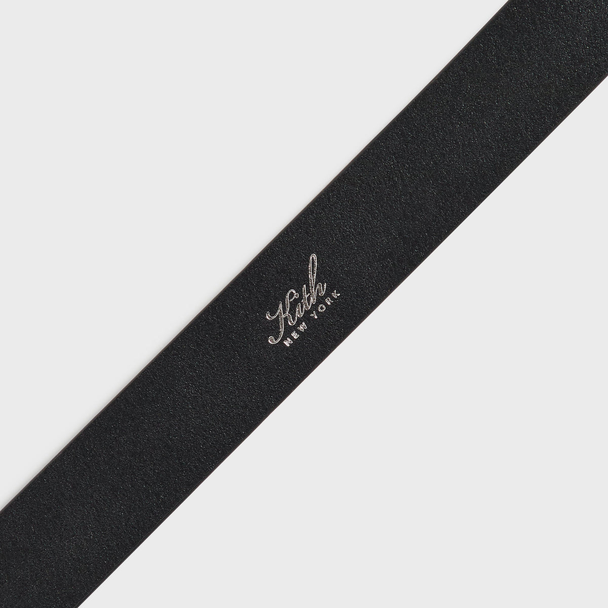 Close-up of the smooth leather and suede center of the black Kith two-tone belt
