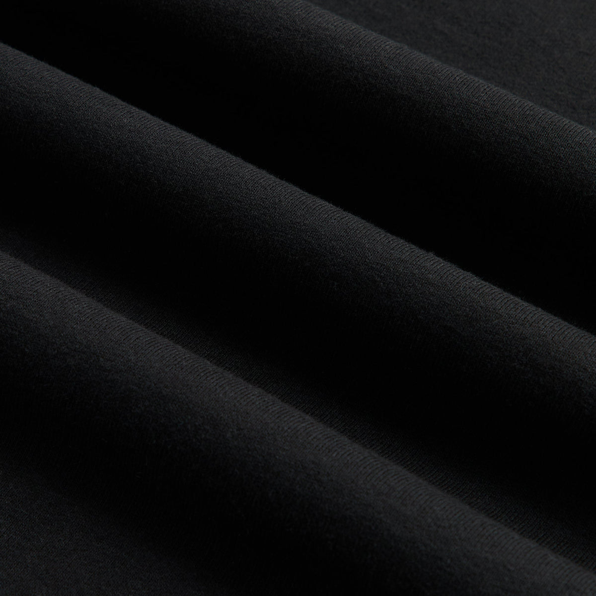Close-up of black cotton fabric of the Kith Retro Logo tee